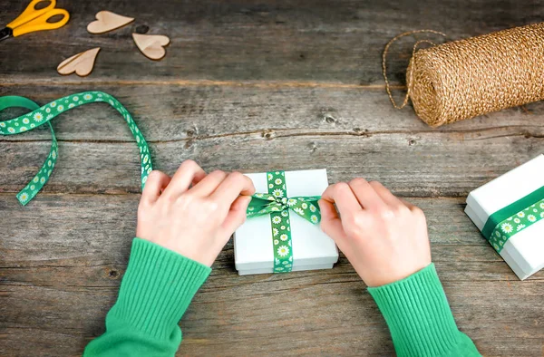 Children Hands Hold Gift Box Bright Green Ribbon Wooden Table —  Fotos de Stock