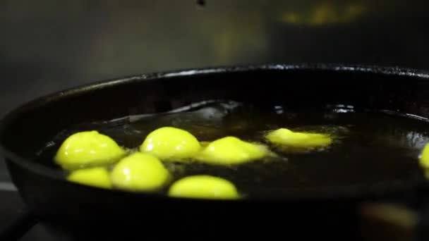 Little Yellow Dumplings Dough Boiling Oil Mans Hand Putting Raw — Stock Video