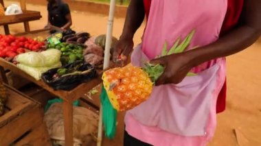 Black hands cutting and peeling pineapple with a knife. High quality FullHD footage
