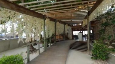 Entrance to the Caribbean beach bar, coming out to the amazing beach with palms. High quality FullHD footage