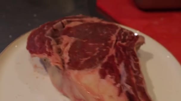 Raw Piece Juicy Ribeye Meat Stake Putting Salt Pepper Cooking — Videoclip de stoc
