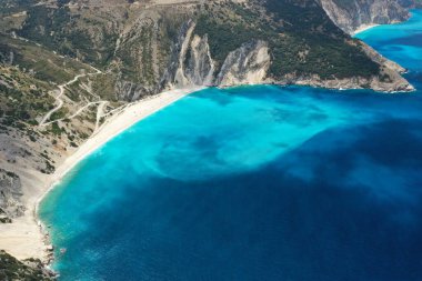 Amazing blue turquoise ocean lagoon and rocky mountain shore, drone aerial shot. High quality image.