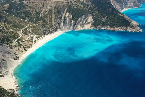 Amazing blue turquoise ocean lagoon and rocky mountain shore, drone aerial shot. High quality image.