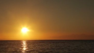 Time lapse of a sunrise, sunup deep in the ocean in the golden color...