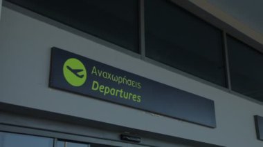 Green departure sign in greek language, airport departure point.. High quality FullHD footage