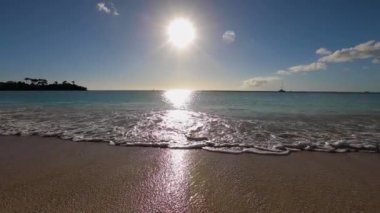Bright huge sun strip, wave coming and going, calm warm idyllic ocean tide. High quality FullHD footage