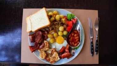Big dish, set toast, potato, bacon, sausages, tomatoes, salad in Odessa, Ukraine. High quality FullHD footage