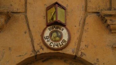 Round street name sign on very old ancient house in street of Odessa, Ukraine. High quality FullHD footage