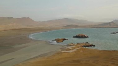 Top shot ocean harbor between mountain and sandy desert, milky sky, golden Peru. High quality FullHD footage