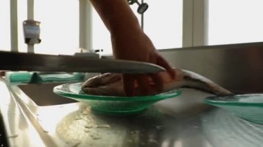 Mans hands cut gutted fish, cut off head, tail, preparation cooking, seviche, Peru. High quality FullHD footage