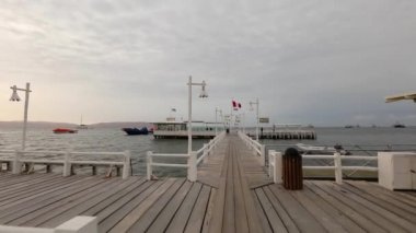 Point of view camera approaching to water cafe on pier, moving on the bridge