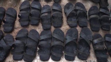 African sandals shoes made of black wheel tires, many pairs of shoes sold market..