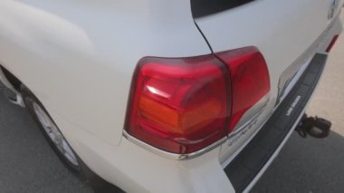 Toyota V6 white jeep backside view, car details, back left headlight..