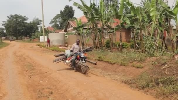 Black Man Driving Bike Carrying Too Many Staff Heavy Loaded — Stock Video