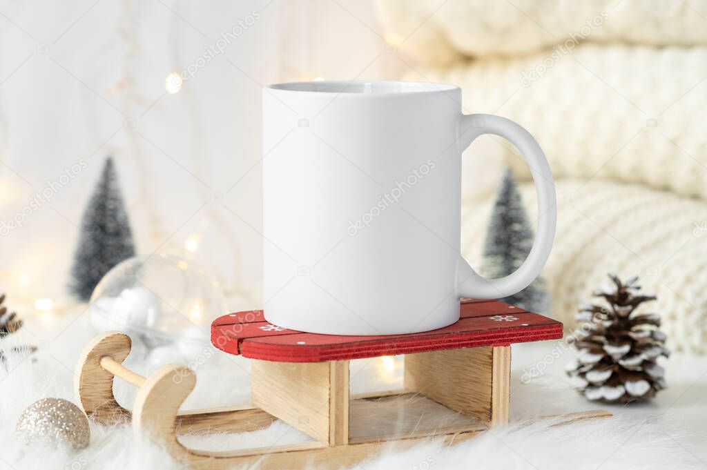 White ceramic tea mug with christmas decoration and copy space for your design. Mockup for xmas promotional content. WInter 11oz cup