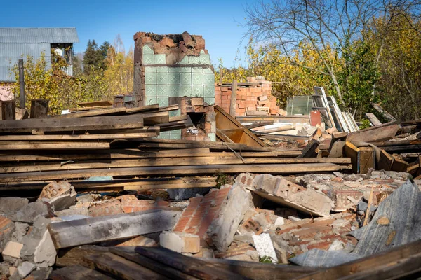 Çöplerin, çöplerin ve çöplerin arka planında duran eski bir kırmızı tuğla binanın harabe fotoğrafı..