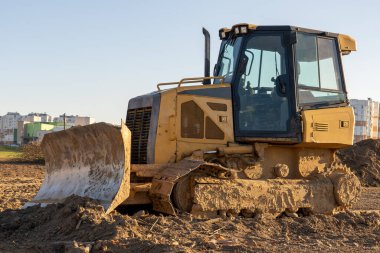 Sarı buldozer, covid tedavisi için hastanenin önündeki zemini düzleştiriyor..