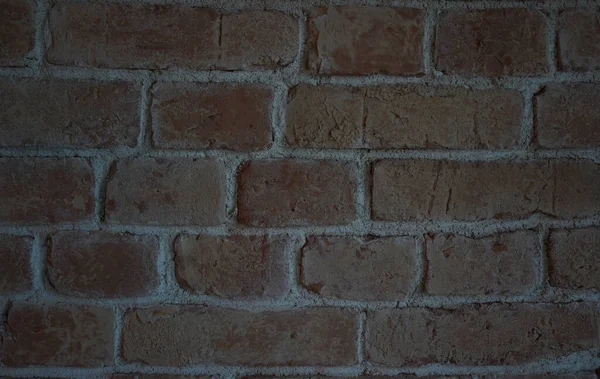 Yarı antika kırmızı tuğla bir duvarın fotoğrafı..