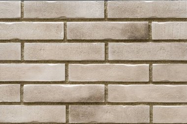 Şık dekoratif bej tuğla duvar arka planının fotoğrafı. Bina, iç mekan, oda. Boşluğu kopyala.