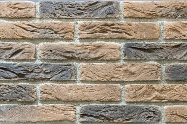 Dekoratif bej ve kahverengi tuğladan duvar altyapısı fotoğrafı. Bina, iç mekan, oda. Boşluğu kopyala.