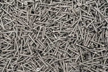 Çelikten vidalar, metal vidalar, demir vidalar, krom vidalar, arka plan olarak vidalar, tahta vidalar. Arkaplan, soyutlama, doku, yapı.