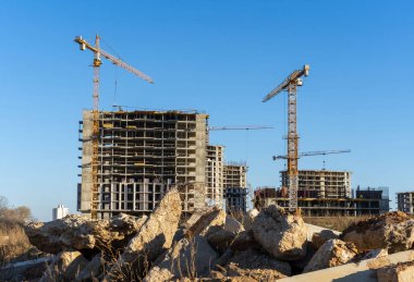 Şantiyenin fotoğrafı ve şehirdeki yüksek bina ve vinçlerin inşaatı. Yapısal kavram.