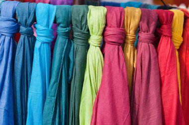 rainbow colored scarves at an outdoor market