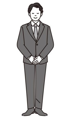 Siyah ve beyaz, elleri bağlı duran bir iş adamının tüm vücudunu gösteriyor..