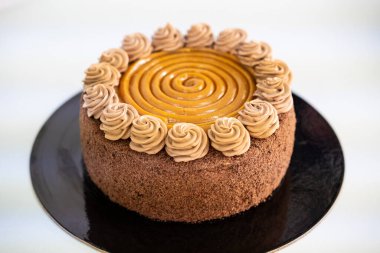  Lezzetli çikolata ve siyah tabakta karamel kek, beyaz arka plan..