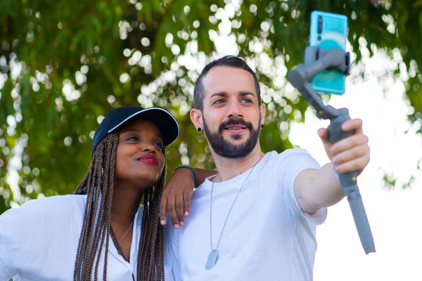 Två vänner av olika etniciteter som tar en selfie med mobilen — Stockfoto