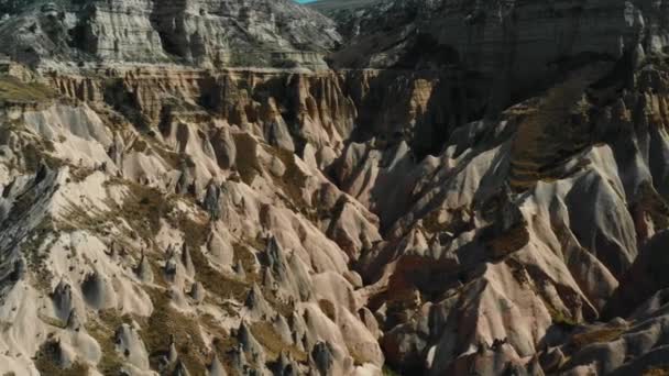 Cinematische antenne landschap van prachtige wildernis, enorme grijze rotsen onder de zonnige berg in Cappadocia Turkije. — Stockvideo