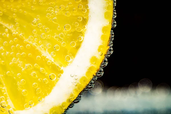 bubbles of  gas on a lemon in soda, sparkling water