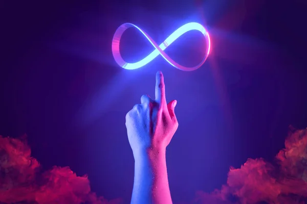 Hand of men pointing on endless infinity sign of virtual reality metaverse digital innovation game or internet online simulation media cyber and world communication connection technology background