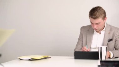 Tablete çizim yapan genç ofis çalışanının görüntülerini tarıyorum.