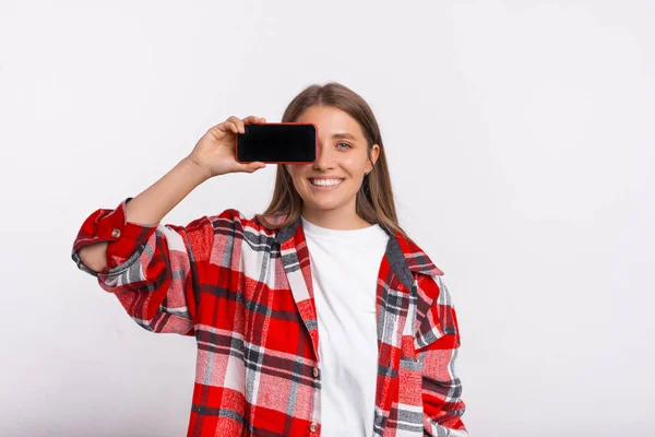 Smiling Woman Wearing Plaid Shirt Covering One Eye Phone She — Stock Photo, Image