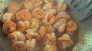 Çinli aşçının tavada kızarmış karides hazırladığı görüntüler.