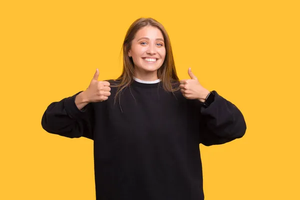 Cheerful Smiling Camera Woman Showing Both Thumbs Portrait Yellow Background — Stock Photo, Image