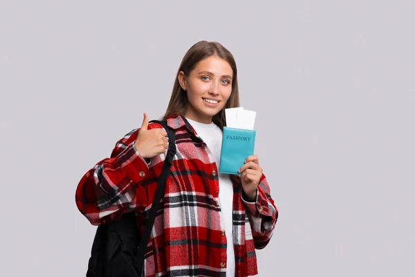 Traveler tourist fun woman in checkered shirt hold on passport with tickets show thumb up like gesture — Fotografia de Stock