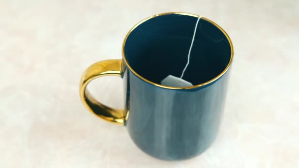 Close up footage of making hot cup of tea, pouring water in cup — Stock Video