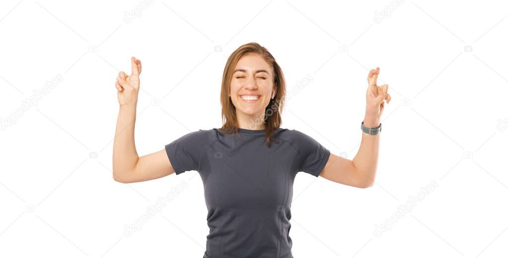 Portrait of young fitness sport woman crossing fingers and wishing