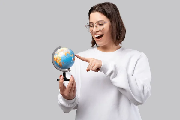 Excited Young Woman Wearing Glasses Pointing Small Earth Globe Studio — Stock Photo, Image