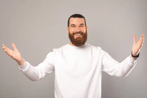 Young smiling bearded hipster man has opened his arms for an embrace. — Stockfoto