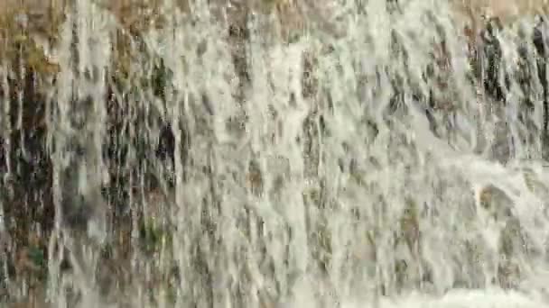 Close up footage of waterfall in slow motion during summer day