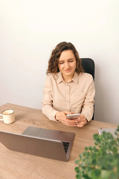 Vertical portrait of happy beautiful office woman using mobile phone and texting message. — Stockfoto