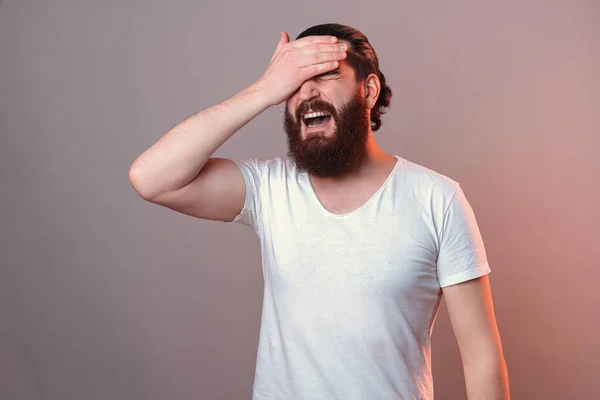 Distraught bearded man is giving himself a facepalm as he forgot something. — Stock Fotó