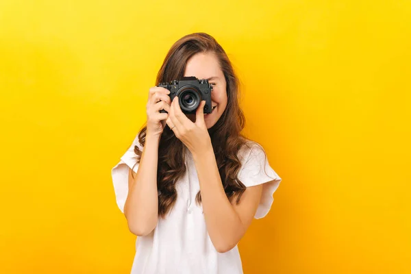 Young Woman Happily Taking Photo Black Camera Yellow Background — Φωτογραφία Αρχείου