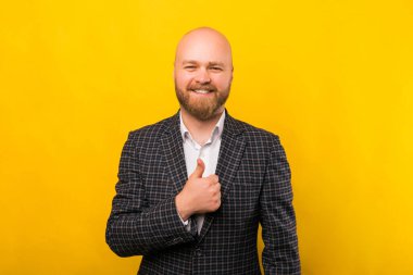 A photo of a young businessman showing a thumb up and smiling at the camera