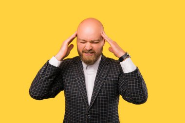 A photo of a young business man being disturbed by the noise
