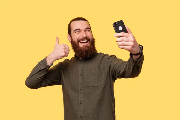 Young Bearded Man Taking Picture Himself Smiling Camera — Stockfoto