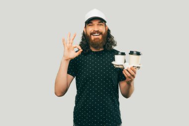 A bearded man highly recommending a brand new coffee